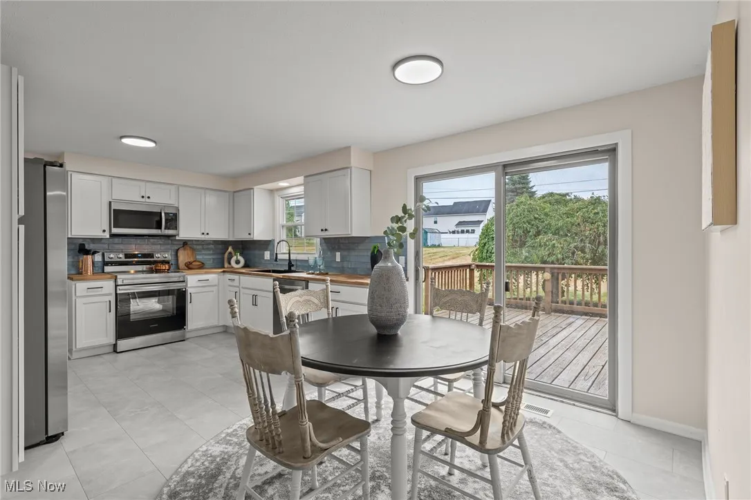 Dining room featuring light tile patterned floors and baseboards