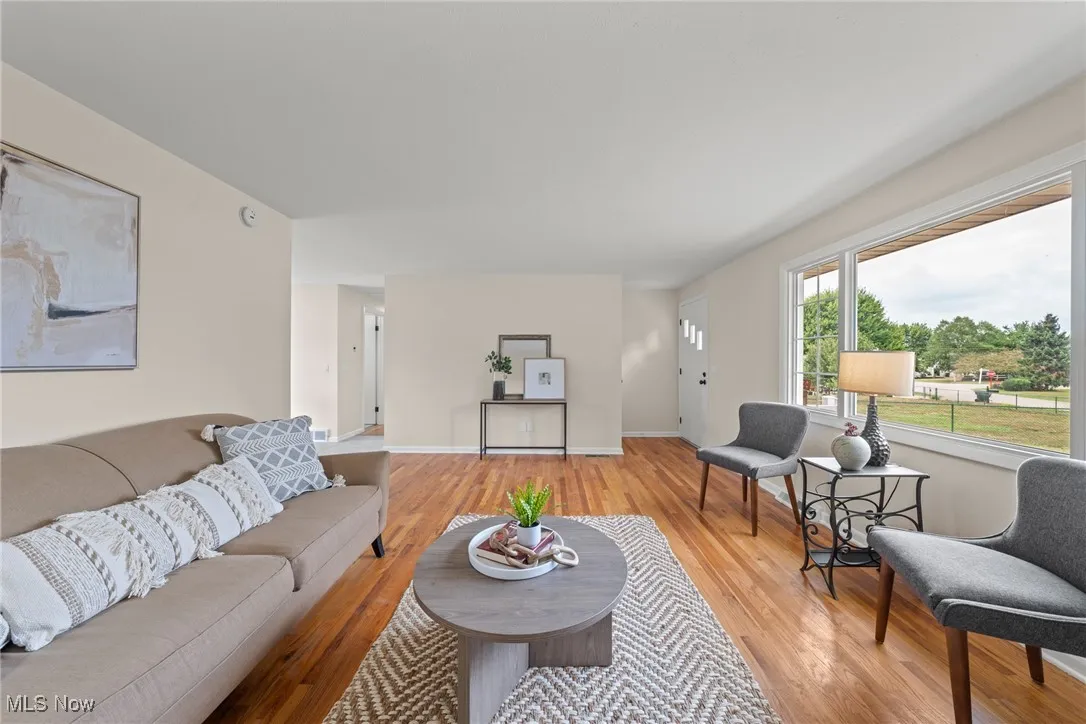 Living area with light wood finished floors and baseboards