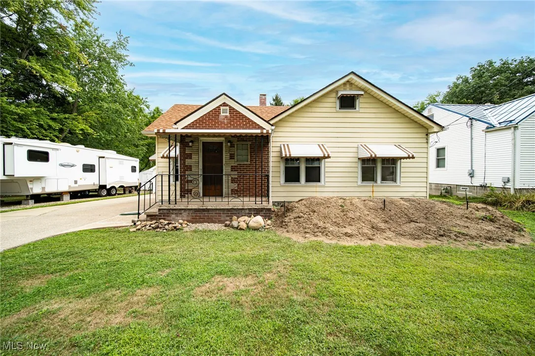 View of front of home featuring a chimney and a front yard