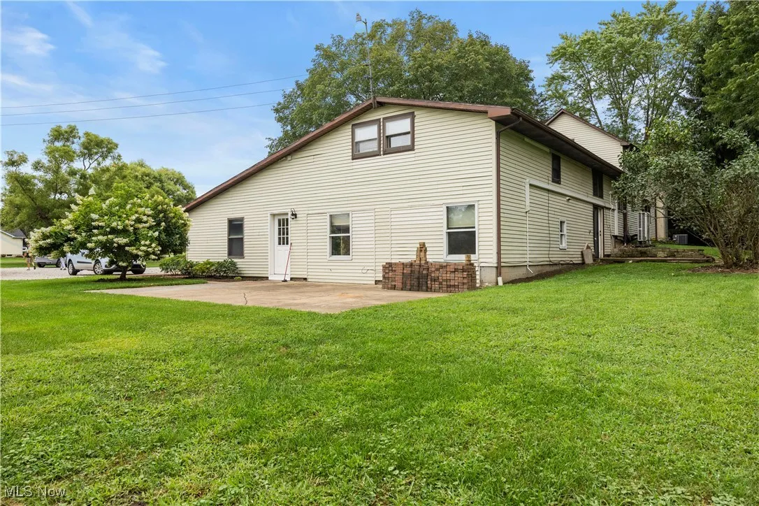 Back of house featuring a patio and a lawn