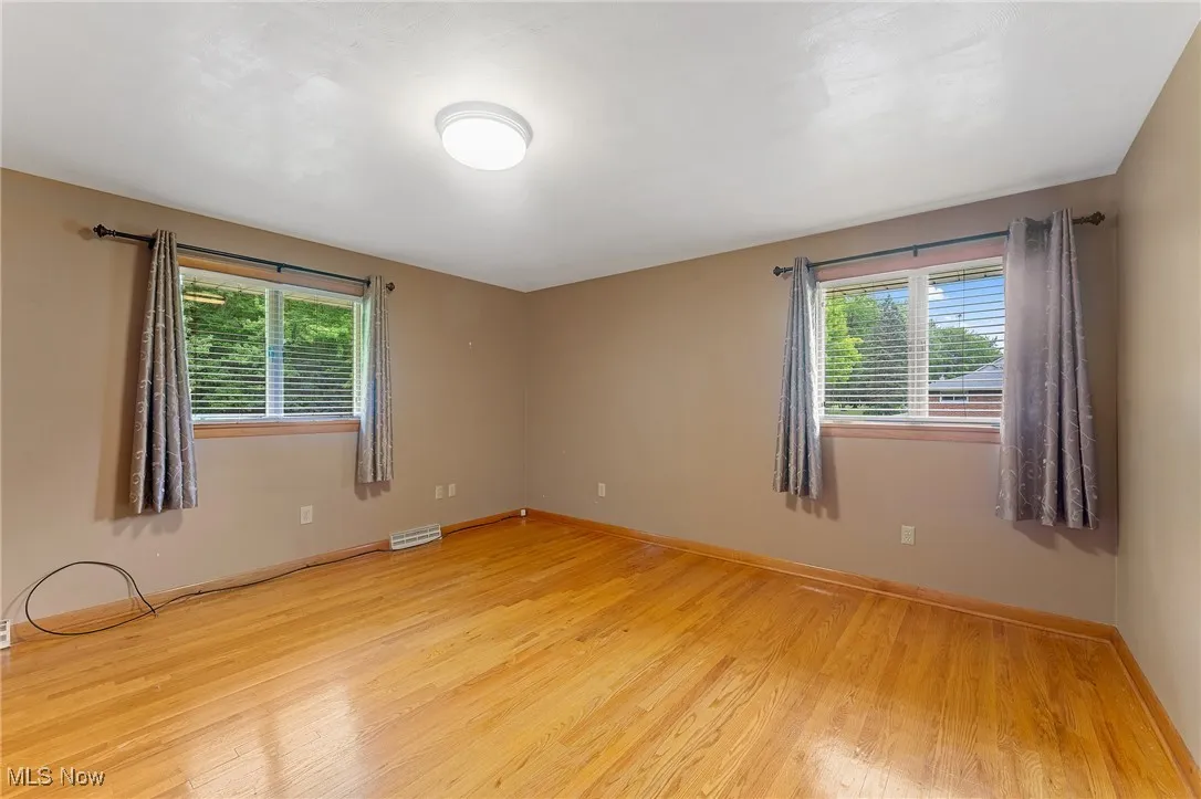 Second bedroom featuring healthy amount of natural light and light wood finished floors
