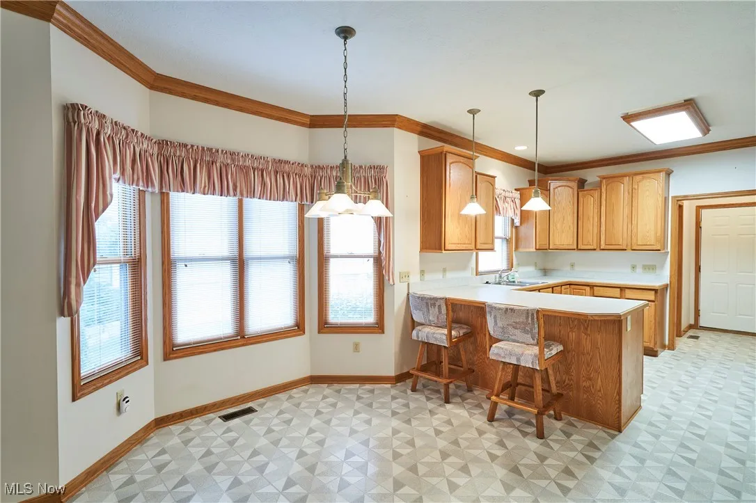 Kitchen featuring a breakfast bar, and bayed eating area