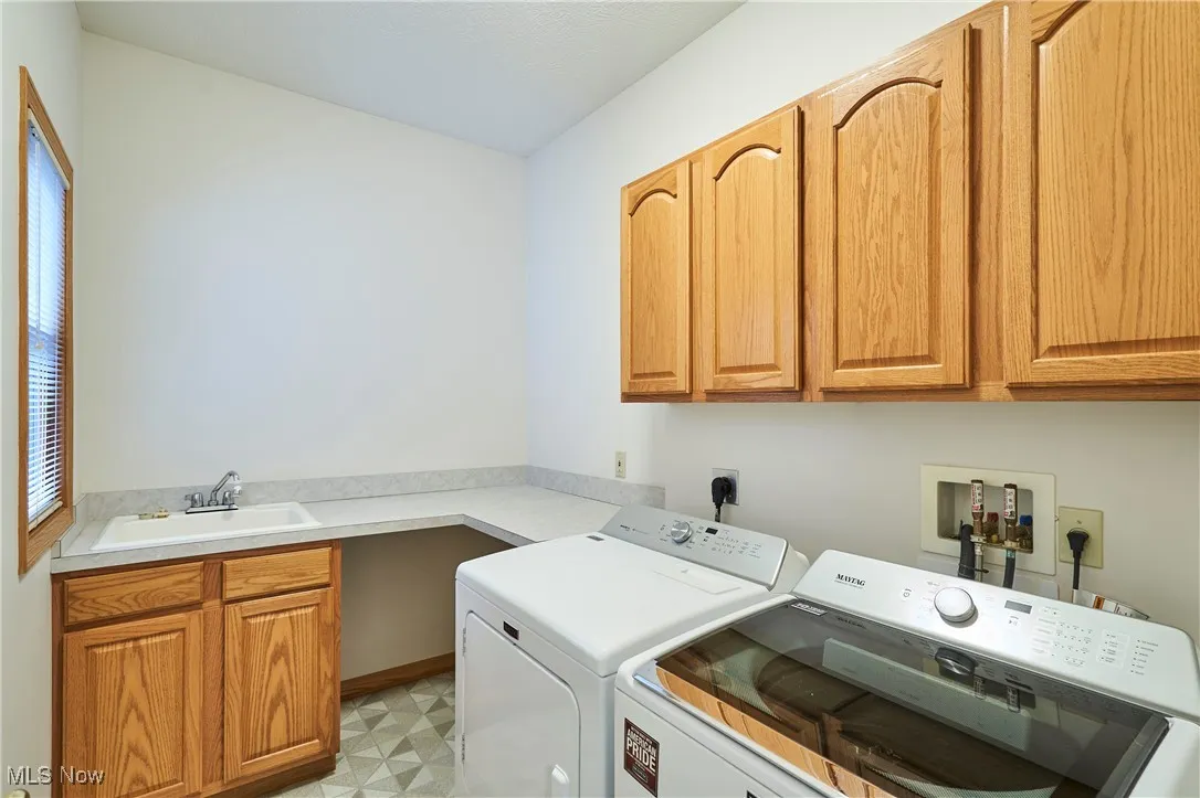 Laundry room featuring cabinet space, sink and counter tops