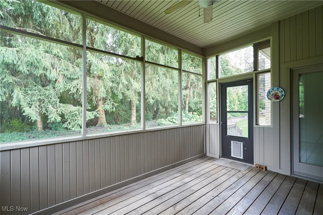 Screened porch featuring a ceiling fan