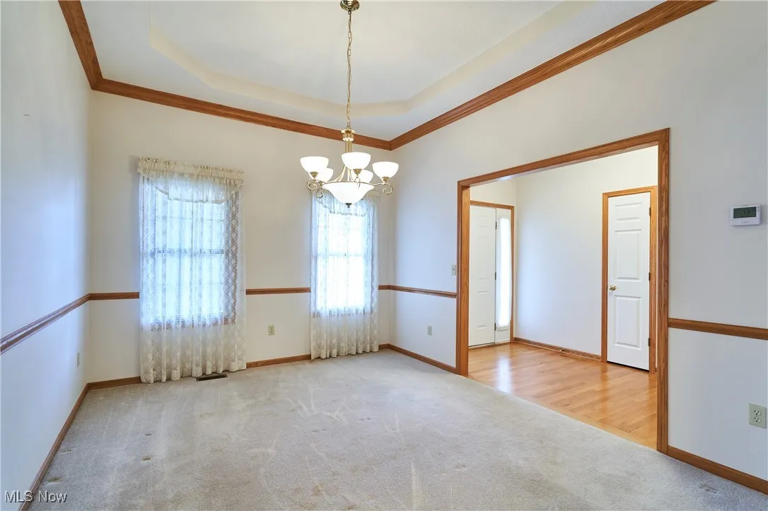 Formal dining room with crown molding and chair railing