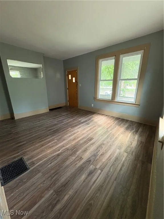 Unfurnished living room with wood finished floors