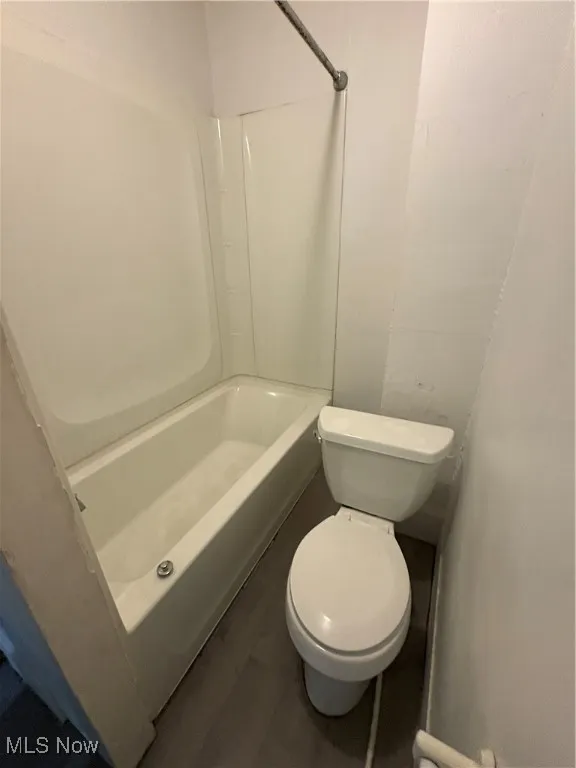 Full bathroom featuring shower / bathtub combination and wood finished floors
