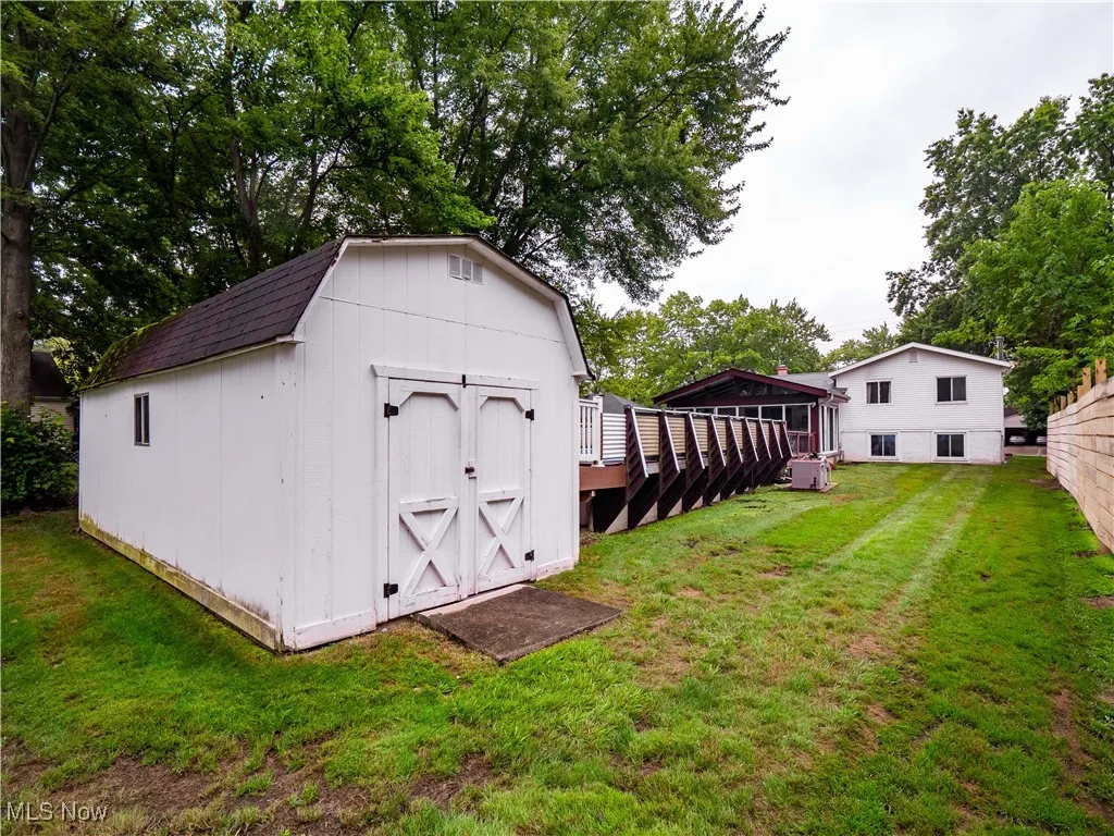 View of shed featuring view of scattered trees