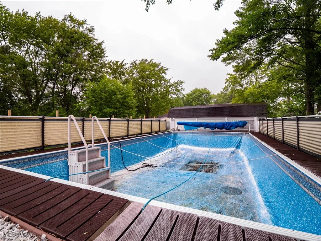 View of swimming pool with a fenced backyard