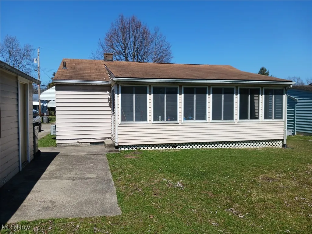 Back of house with a sunroom