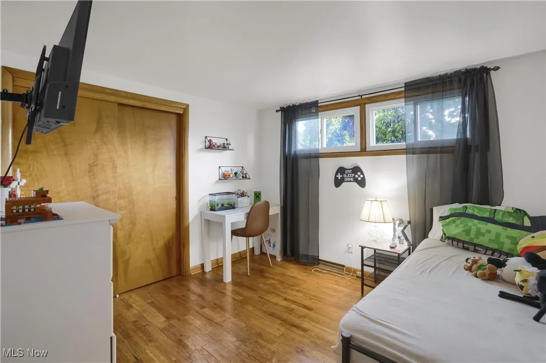 Bedroom with light wood-type flooring and a closet