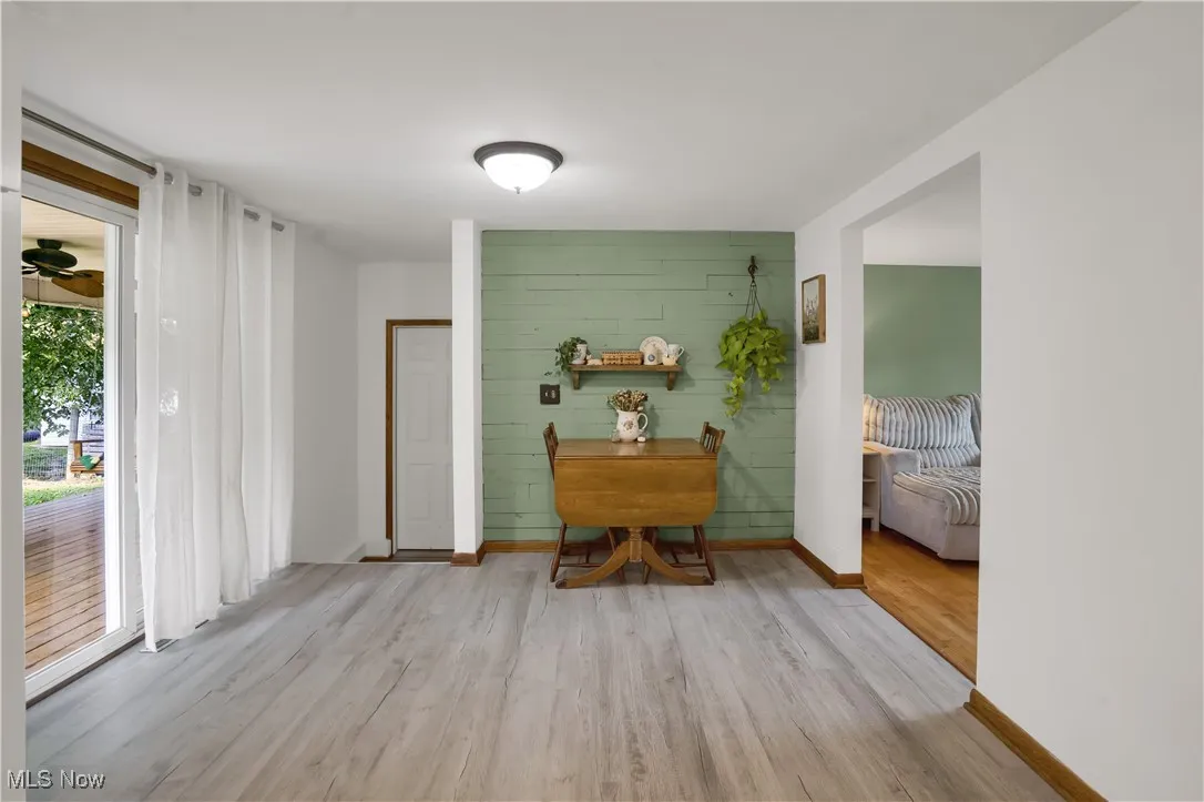 Living area featuring light wood finished floors and baseboards