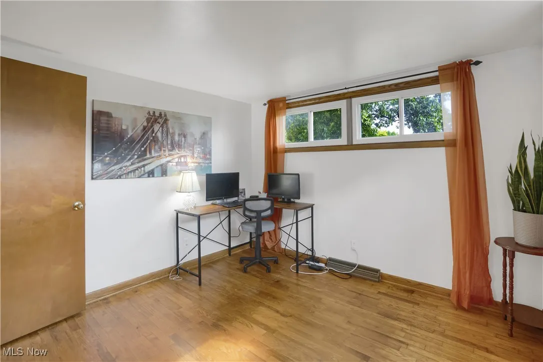Office area with wood finished floors and baseboards