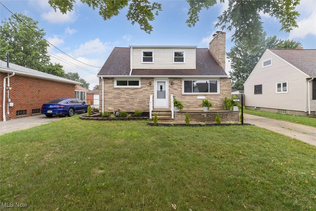 Bungalow-style home with a front yard, a chimney, brick siding, and a shingled​​‌​​​​‌​​‌‌​‌‌​​​‌‌​‌​‌​‌​​​‌​​ roof