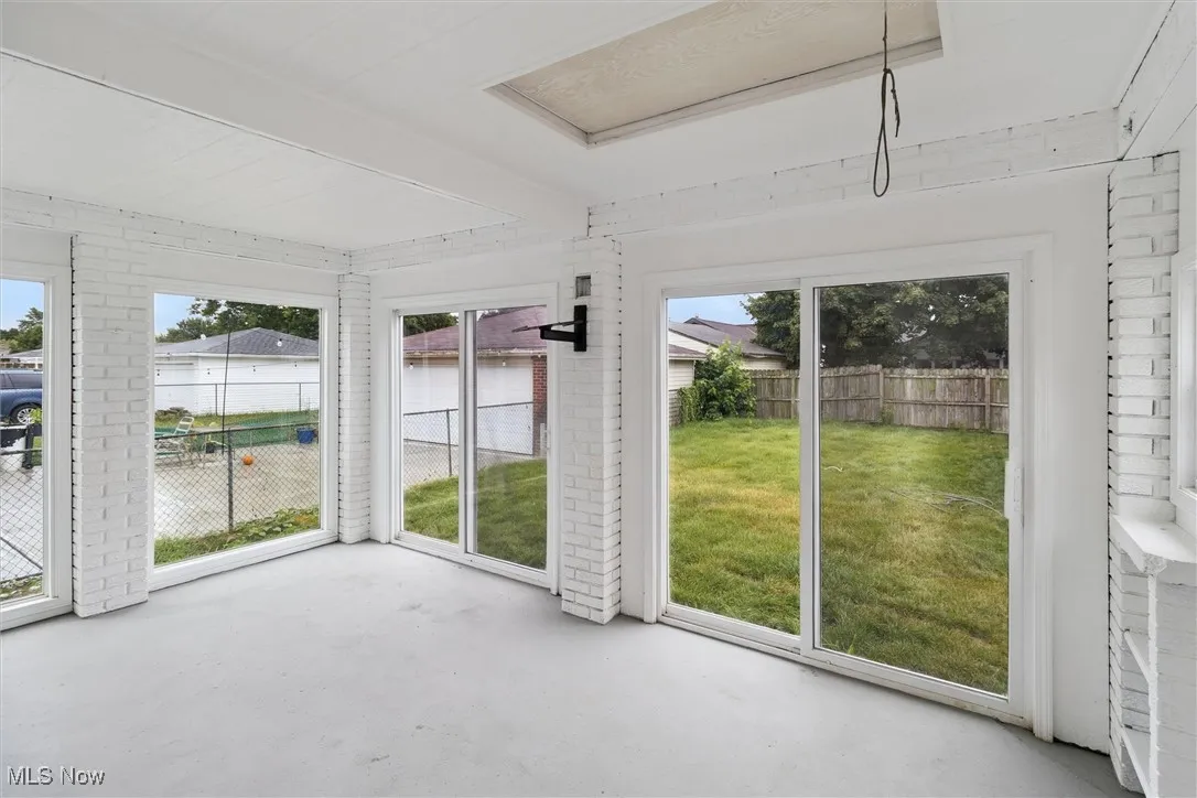 Unfurnished sunroom featuring a water view