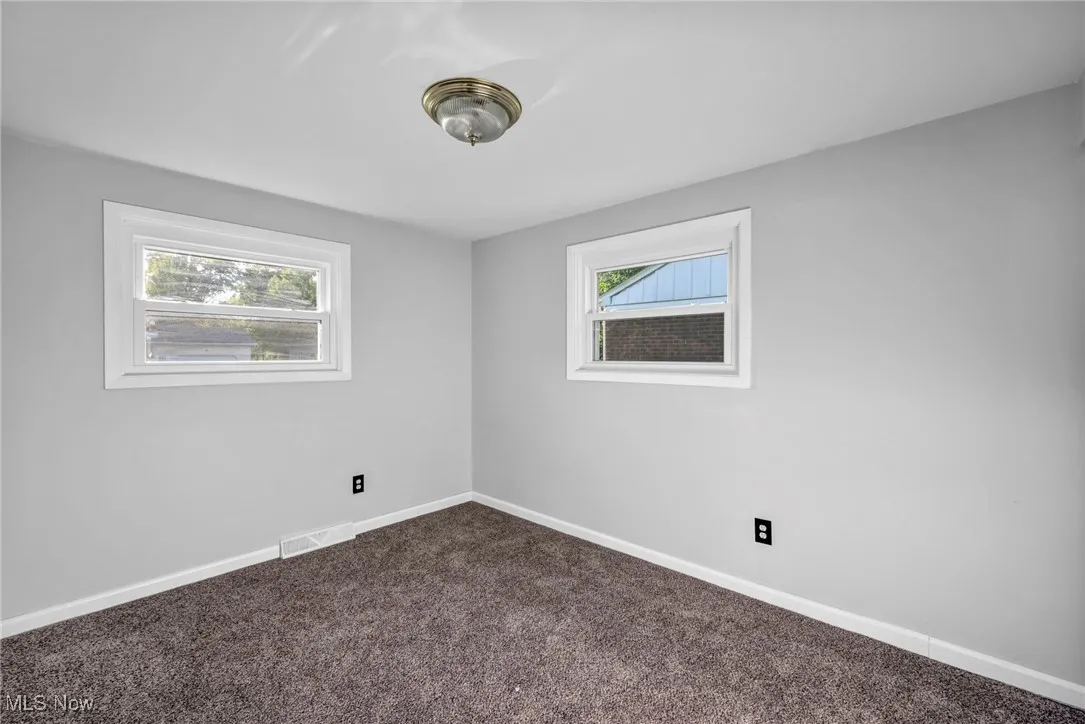 3rd Bedroom featuring baseboards and dark carpet