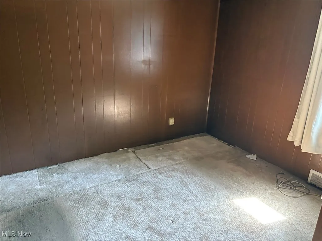Spare room with wood walls