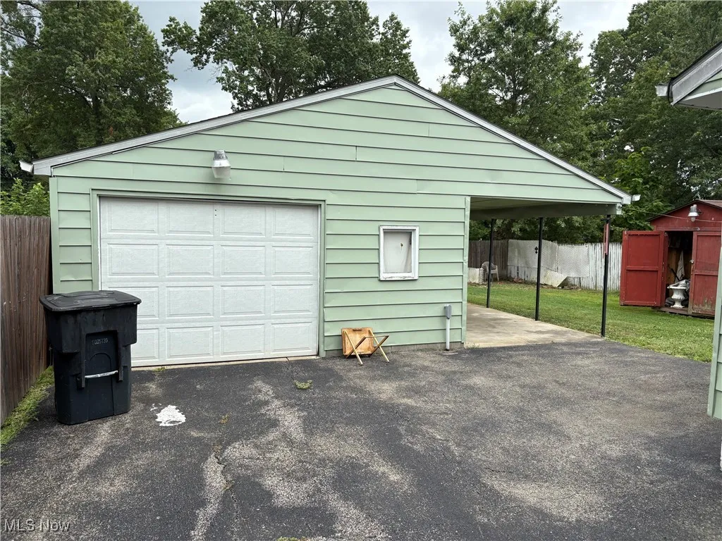 Garage with a detached garage and driveway