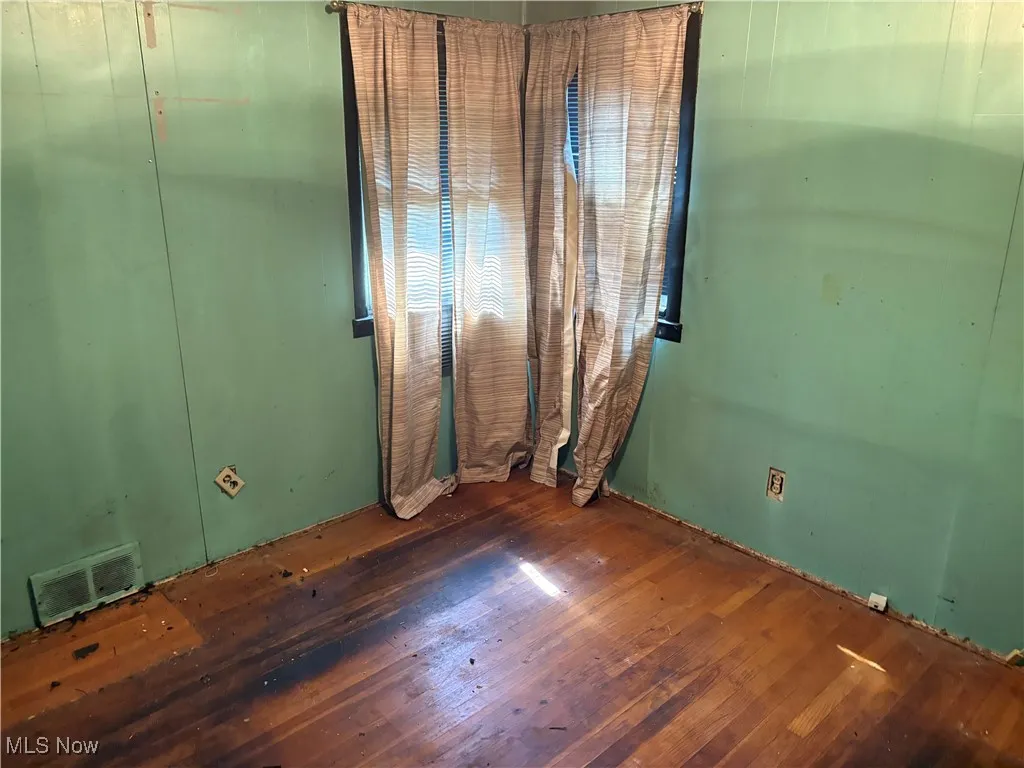 Spare room featuring hardwood / wood-style flooring