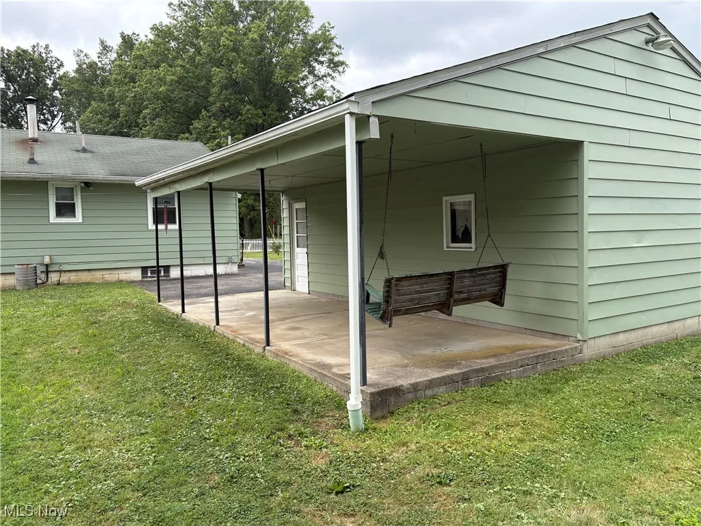 Back of house featuring a yard and a patio area