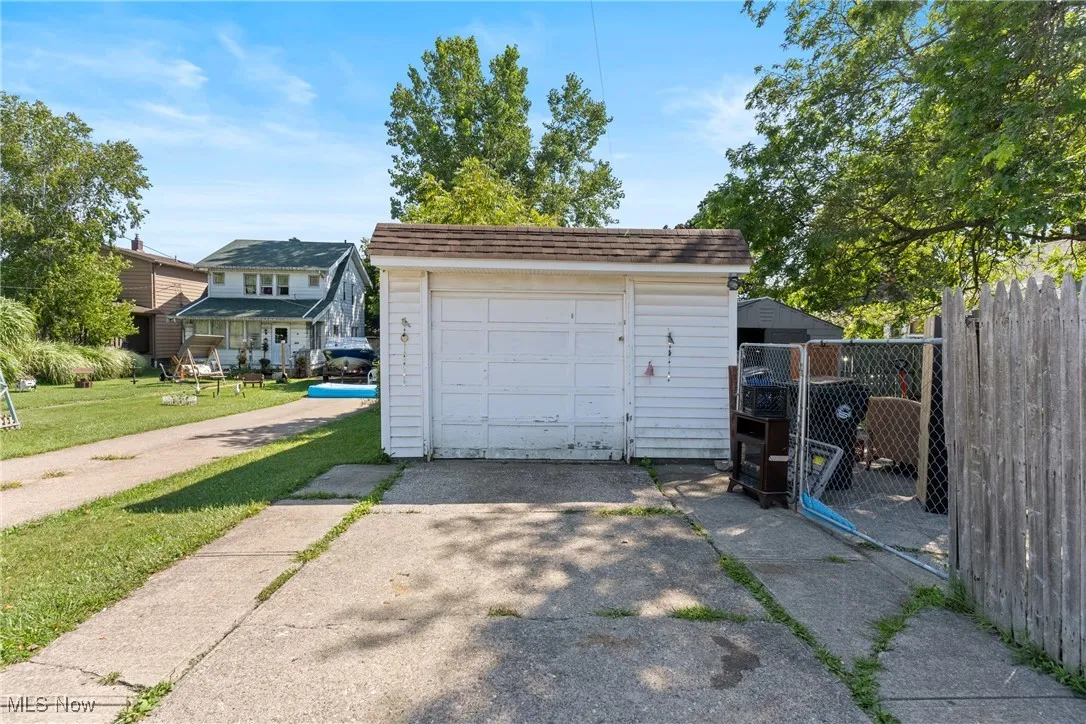 Detached garage featuring additional parking on side