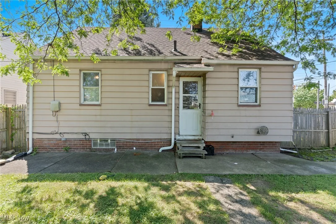 Back of house with a patio area, a shingled roof, and entry steps