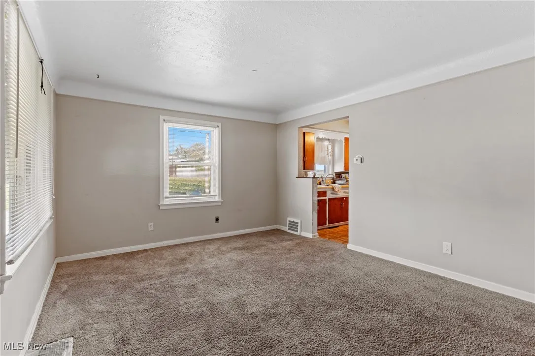 Carpeted with entry to kitchen and hallway