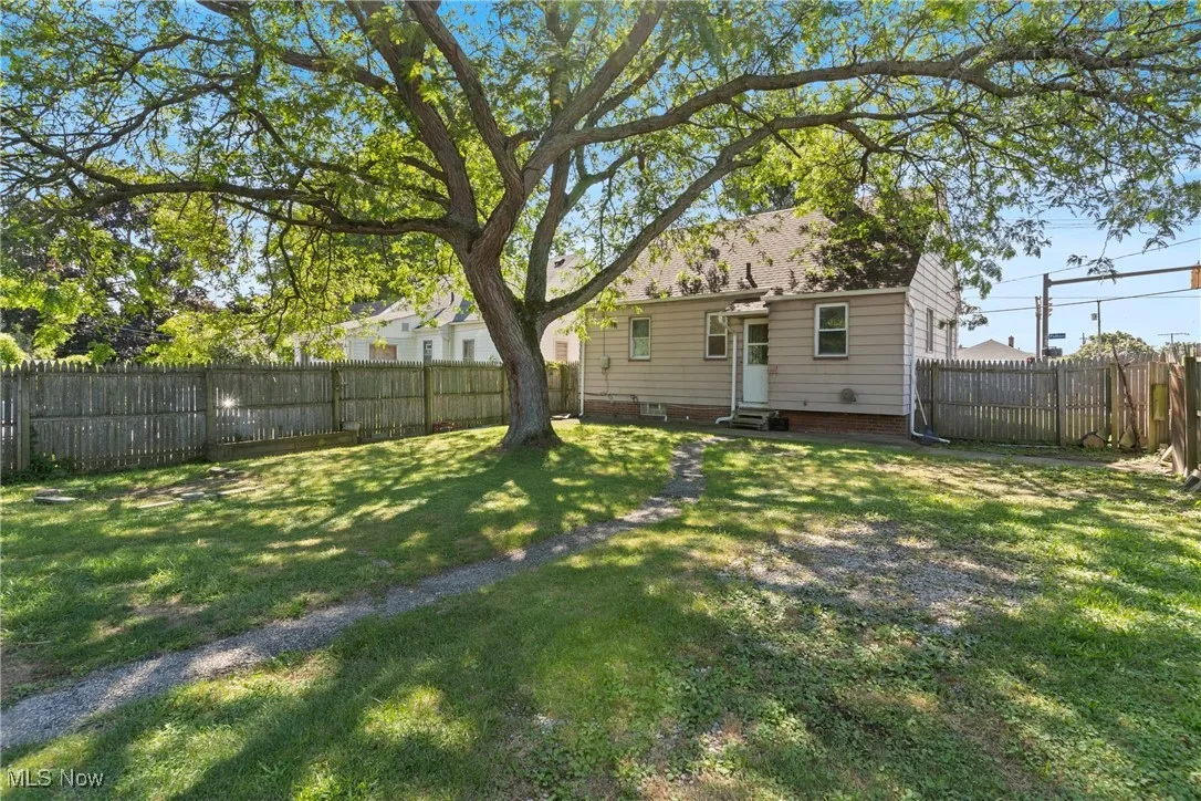 Back of house featuring a fenced backyard and entry steps