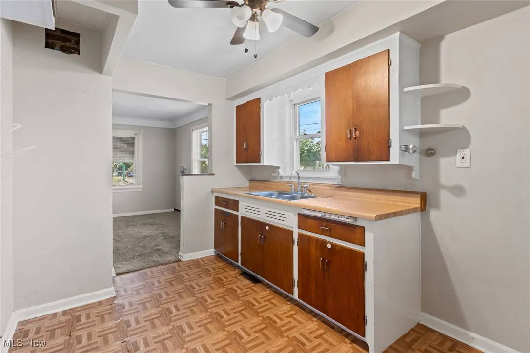 Kitchen featuring a ceiling fan, open shelving, eat in space, with gas stove hook up.