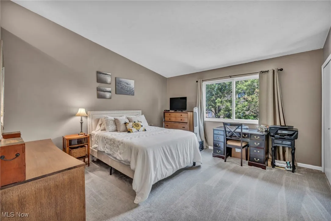 Owners Bedroom featuring vaulted ceiling, carpet flooring double closets