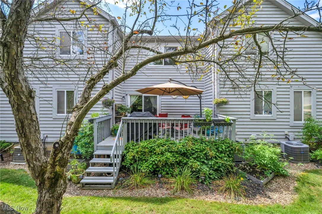 Rear view of property featuring a wooden deck