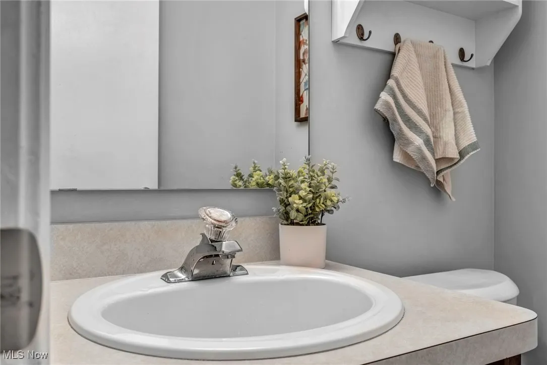Half bathroom featuring toilet and vanity