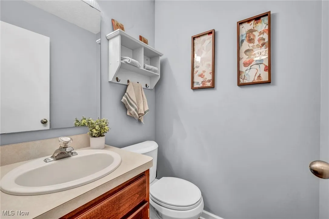 Half bath with vanity and toilet off the front entrance to home