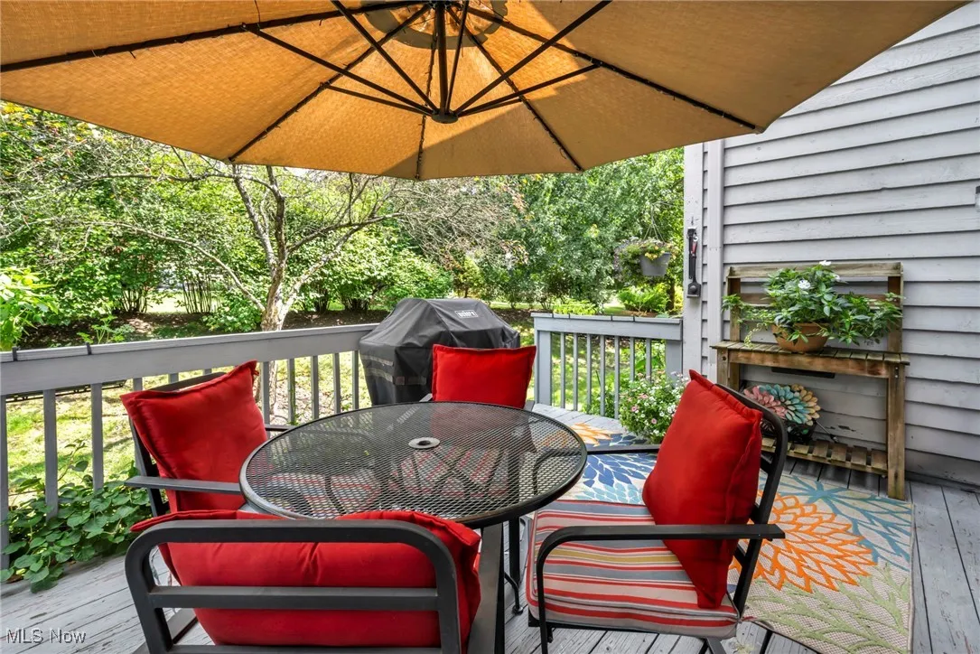 Deck with outdoor dining space and area for grilling
