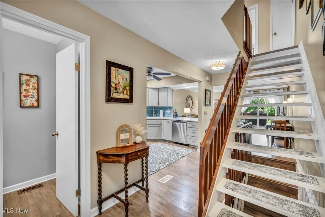 Entrance with view of 1/2 bath & stairwell upstairs