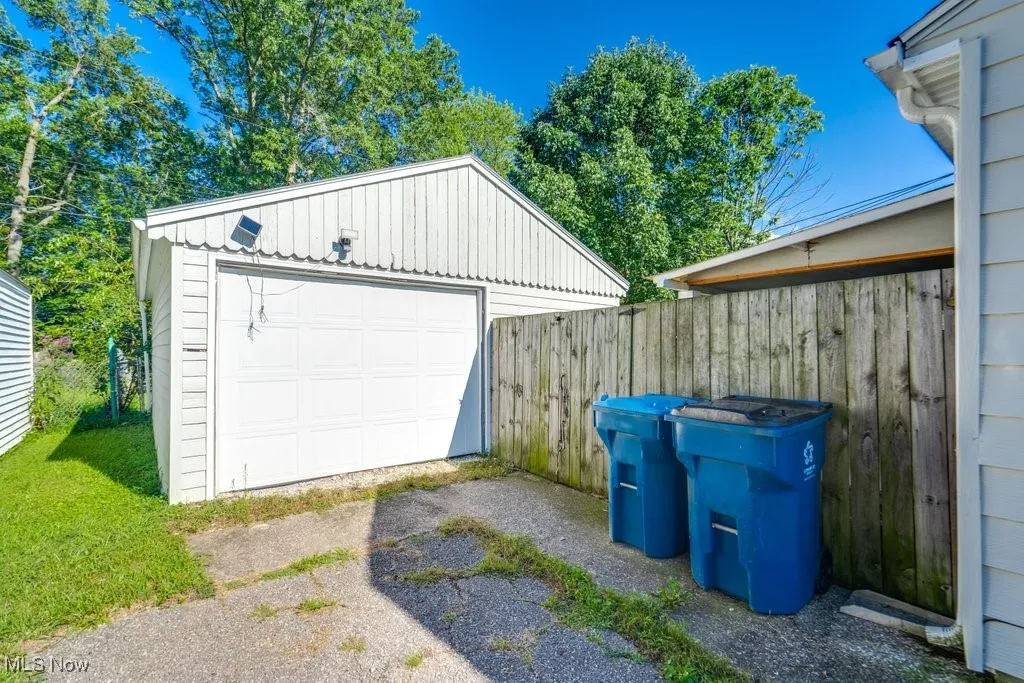 Detached garage featuring asphalt driveway