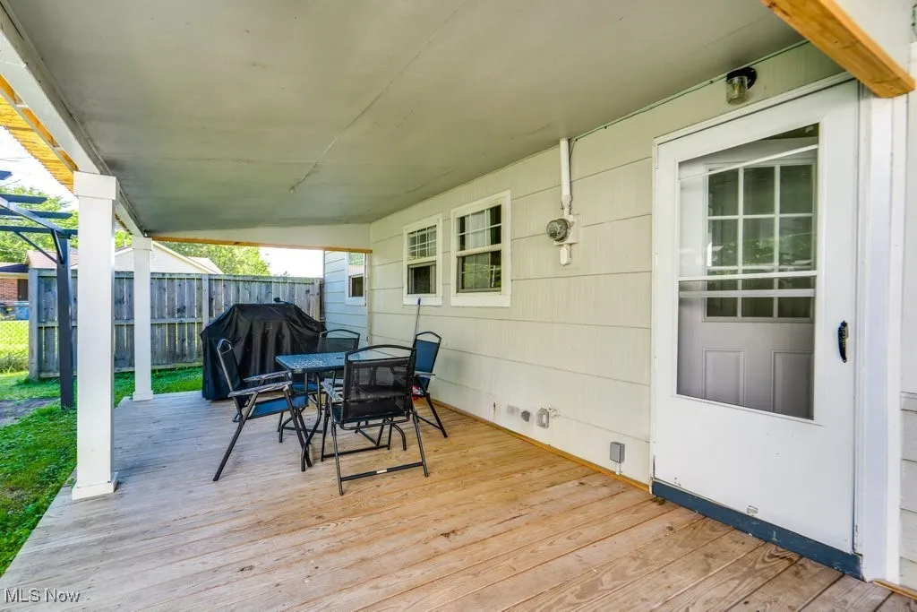 Wooden deck featuring outdoor dining area and area for grilling