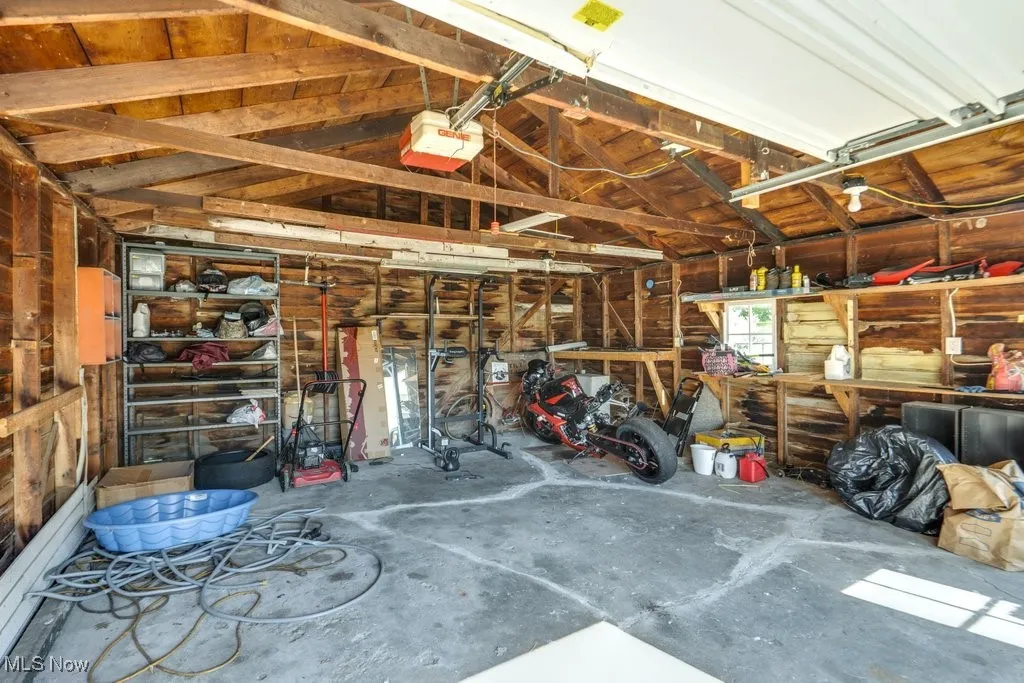 Garage with a garage door opener and a workshop area