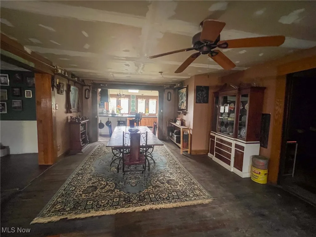 Dining area with dark wood finished floors and a ceiling fan