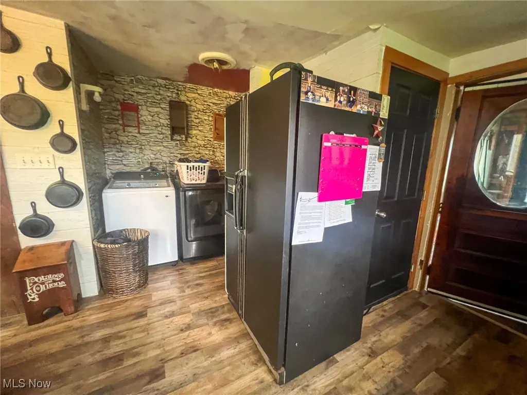 Laundry room with dark wood finished floors and washer and dryer