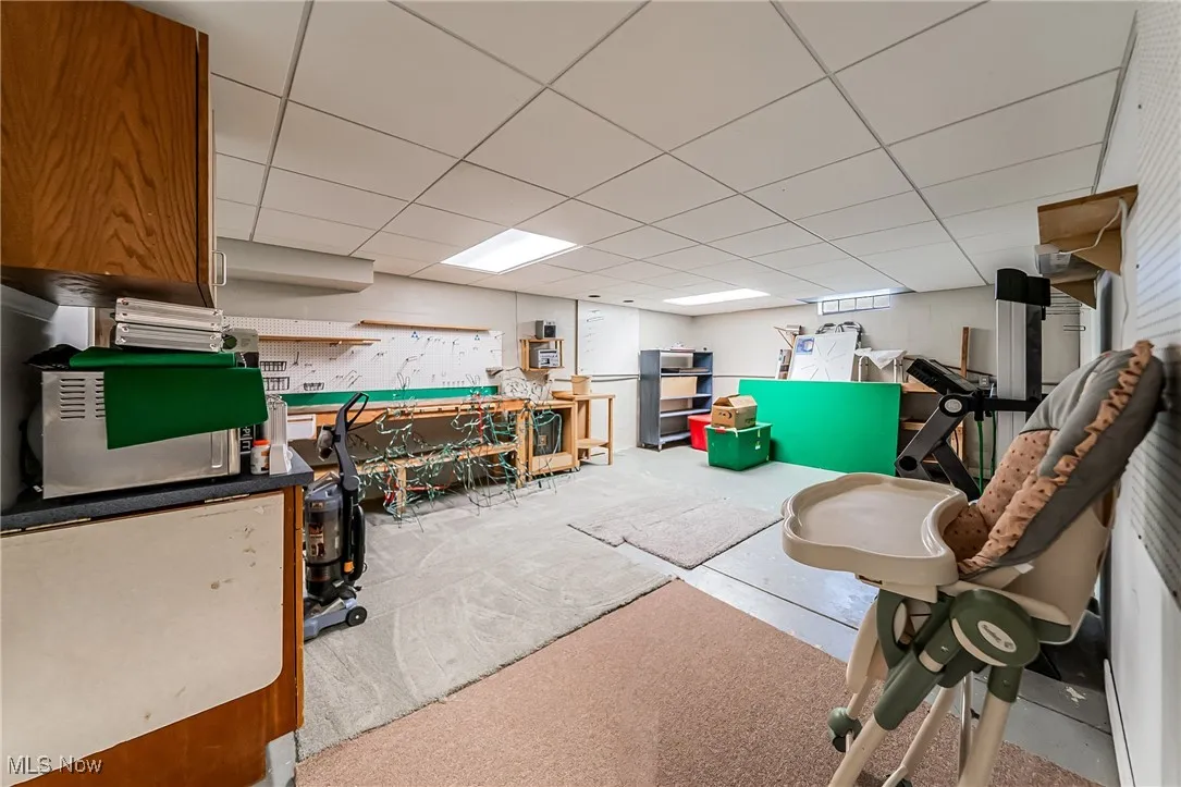 Finished basement featuring a drop ceiling