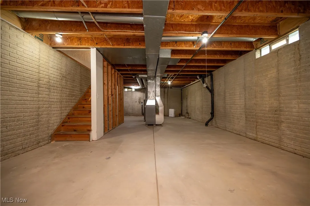 Basement with stairway and heating unit