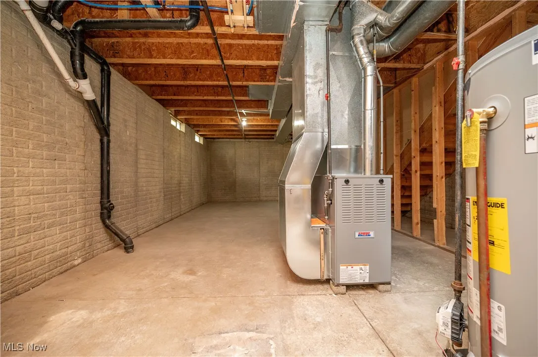 Unfinished basement with water heater and heating unit