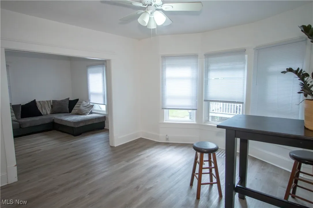 Dining area featuring wood finished floors, ceiling fan, and a desk