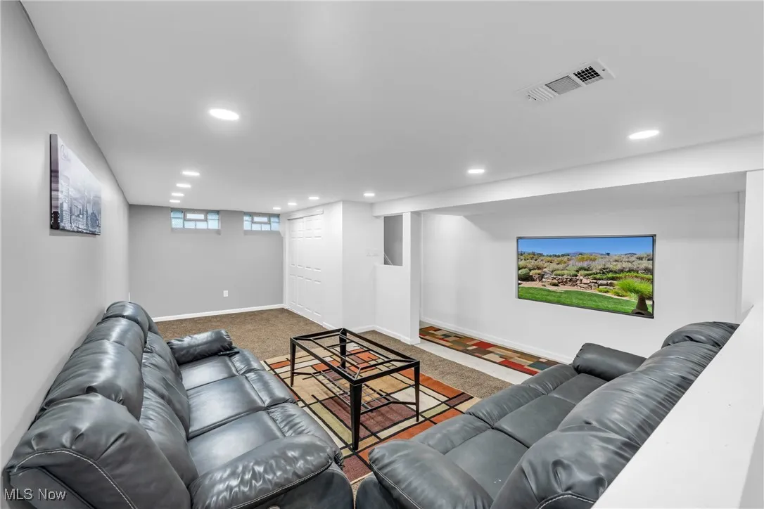 Living room with recessed lighting and carpet