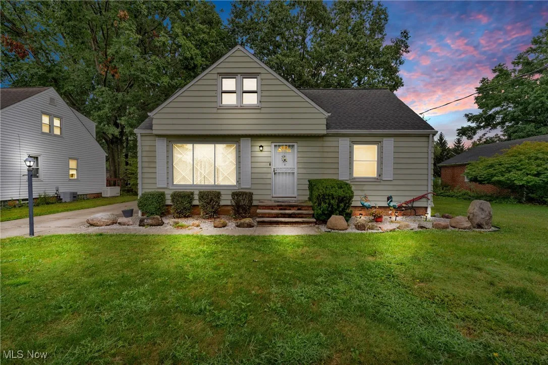 Bungalow-style house featuring a front lawn and a shingled roof