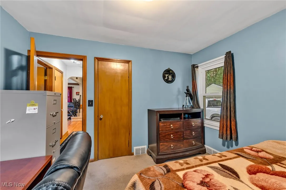 Bedroom featuring carpet floors and baseboards