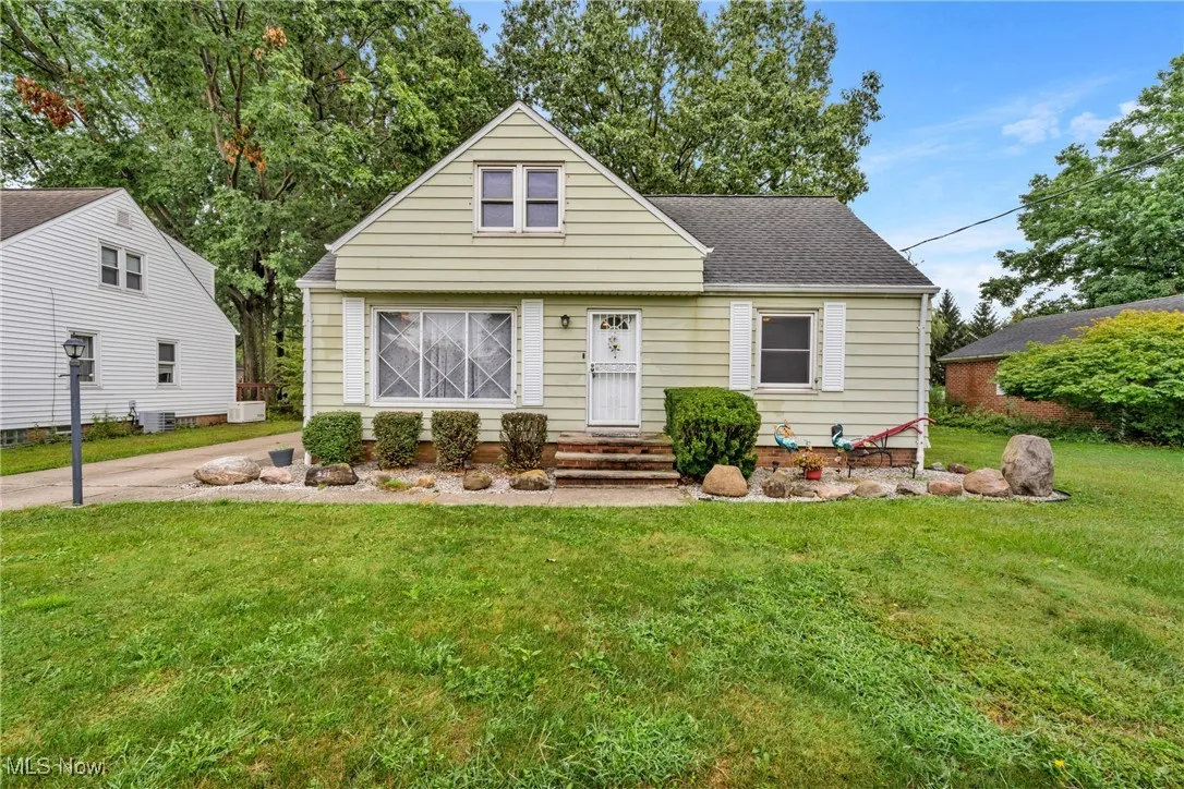 Bungalow-style home featuring a front lawn and a shingled roof