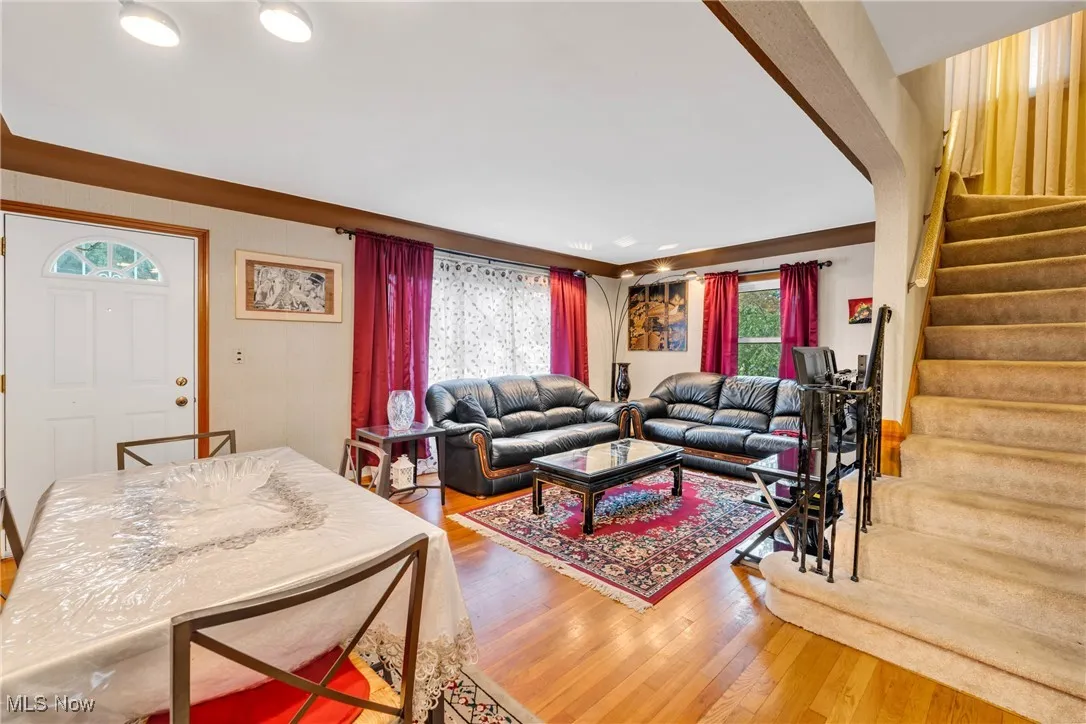 Living area with stairs and wood finished floors
