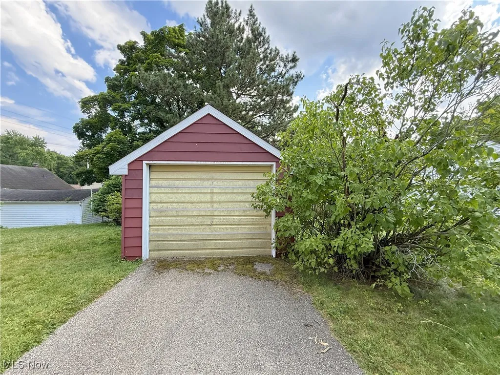 Detached garage with asphalt driveway